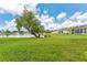 Expansive backyard with lush green grass and a tranquil pond view, perfect for relaxation at 5309 Spectacular Bid Dr, Wesley Chapel, FL 33544