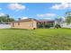 Charming home features a well-manicured lawn, mature landscaping, and a screened-in lanai at 5309 Spectacular Bid Dr, Wesley Chapel, FL 33544