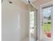 Bright bathroom boasts tiled shower with glass doors and views of the outdoors through the nearby window at 5309 Spectacular Bid Dr, Wesley Chapel, FL 33544