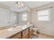 Bathroom with a light wood vanity, granite counters, framed mirror, and tile floors at 5309 Spectacular Bid Dr, Wesley Chapel, FL 33544
