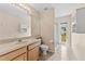 Bathroom with a single vanity, framed mirror, and walk-in shower with sliding doors at 5309 Spectacular Bid Dr, Wesley Chapel, FL 33544