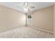 Carpeted bedroom with neutral walls, a ceiling fan and a window at 5309 Spectacular Bid Dr, Wesley Chapel, FL 33544