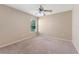 Comfortable bedroom with a ceiling fan, carpeted floors and a window at 5309 Spectacular Bid Dr, Wesley Chapel, FL 33544