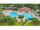 Aerial view of community pool and playground with ample seating and lush landscaping at 5309 Spectacular Bid Dr, Wesley Chapel, FL 33544
