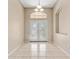 Bright entryway featuring decorative double doors, neutral walls, and tile flooring at 5309 Spectacular Bid Dr, Wesley Chapel, FL 33544