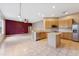 Open kitchen with stainless steel appliances, ample cabinets and tiled flooring with an island at 5309 Spectacular Bid Dr, Wesley Chapel, FL 33544