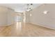 Large living room featuring hardwood floors, neutral walls, ceiling fan, and lots of natural light at 5309 Spectacular Bid Dr, Wesley Chapel, FL 33544