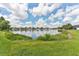 Beautiful backyard featuring lush greenery and a tranquil pond, creating a serene outdoor space at 5309 Spectacular Bid Dr, Wesley Chapel, FL 33544