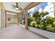The screened lanai offers a serene outdoor space with lovely landscaping and a ceiling fan at 5309 Spectacular Bid Dr, Wesley Chapel, FL 33544