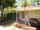 Inviting front porch with seating and a decorative pelican statue, framed by lush greenery at 5468 26Th N Ave, St Petersburg, FL 33710