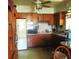 Functional kitchen with wood cabinets, white appliances, and a cozy breakfast nook at 5468 26Th N Ave, St Petersburg, FL 33710
