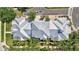 Aerial view of townhome roofs surrounded by lush greenery and community landscaping showcasing meticulous maintenance at 5518 Luminar Pointe Ln, Apollo Beach, FL 33572