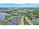 Scenic aerial view of a Primary-planned community with mature trees, lakes, and many amenities at 5518 Luminar Pointe Ln, Apollo Beach, FL 33572