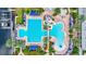 Community pool and water slide with abundant lounge seating surrounded by palm trees and well-kept landscaping at 5518 Luminar Pointe Ln, Apollo Beach, FL 33572