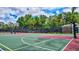Fenced-in community basketball court with nets, benches, and painted lines for a professional playing experience at 5518 Luminar Pointe Ln, Apollo Beach, FL 33572
