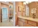 Bright bathroom with a vanity, mirror, neutral countertops, and colorful shower curtain at 5518 Luminar Pointe Ln, Apollo Beach, FL 33572