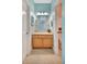 Colorful bathroom featuring a vanity with a framed mirror and a separate toilet and shower area at 5518 Luminar Pointe Ln, Apollo Beach, FL 33572