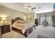 Spacious bedroom with neutral carpet, ceiling fan, and ornate furniture set at 5518 Luminar Pointe Ln, Apollo Beach, FL 33572