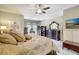 Bedroom with a large bed, dresser with mirror, ceiling fan, and a flat screen tv at 5518 Luminar Pointe Ln, Apollo Beach, FL 33572