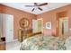 Bedroom featuring a floral bedspread, dresser with a round mirror, and ceiling fan at 5518 Luminar Pointe Ln, Apollo Beach, FL 33572