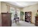 Bedroom with a vanity, bookshelf, two windows, and neutral-colored carpet at 5518 Luminar Pointe Ln, Apollo Beach, FL 33572