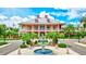 Gorgeous community clubhouse with a front fountain, bright paint, and lush landscaping for an elegant and welcoming entrance at 5518 Luminar Pointe Ln, Apollo Beach, FL 33572
