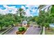 A secure gated community entrance with lush landscaping, mature trees, and a guard house at 5518 Luminar Pointe Ln, Apollo Beach, FL 33572