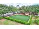 Well-maintained community dog park with green artificial turf, playground, and benches, perfect for pets and their owners at 5518 Luminar Pointe Ln, Apollo Beach, FL 33572