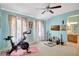 Spacious exercise room with a Peloton bike, soft natural light, and a view of the ensuite bath at 5518 Luminar Pointe Ln, Apollo Beach, FL 33572