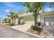 Exterior shot of two-story home with two car garage and beautiful landscaping at 5518 Luminar Pointe Ln, Apollo Beach, FL 33572