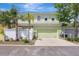 Exterior view of a two-story home with a two-car garage, tidy landscaping, and a well-kept yard at 5518 Luminar Pointe Ln, Apollo Beach, FL 33572