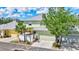 Charming two-story home featuring lush landscaping, a metal roof, and an attached two-car garage at 5518 Luminar Pointe Ln, Apollo Beach, FL 33572