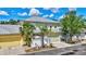 Charming two-story home featuring lush landscaping, a metal roof, and an attached two-car garage at 5518 Luminar Pointe Ln, Apollo Beach, FL 33572