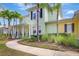 Two-story home with lush, mature landscaping, walkway, and a welcoming front porch at 5518 Luminar Pointe Ln, Apollo Beach, FL 33572