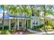 Charming two-story home with lush landscaping, front porch swing, and inviting curb appeal at 5518 Luminar Pointe Ln, Apollo Beach, FL 33572