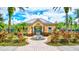 Exterior of community fitness center surrounded by lush tropical landscaping and decorative rock feature at 5518 Luminar Pointe Ln, Apollo Beach, FL 33572