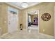 Charming foyer featuring decorative accents, marble floors, and access to an office space at 5518 Luminar Pointe Ln, Apollo Beach, FL 33572