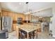 Open-concept kitchen featuring a large island, stainless steel appliances, and adjacent dining area at 5518 Luminar Pointe Ln, Apollo Beach, FL 33572