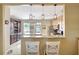 Open kitchen with an island, stainless steel appliances, and an integrated wine cooler and bar area at 5518 Luminar Pointe Ln, Apollo Beach, FL 33572