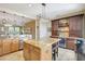 The kitchen features a wine cooler, granite countertops, and an island with barstool seating at 5518 Luminar Pointe Ln, Apollo Beach, FL 33572