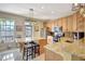 Bright kitchen boasts an island with stool seating, granite countertops, and stainless steel appliances at 5518 Luminar Pointe Ln, Apollo Beach, FL 33572