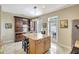 Stylish kitchen with stainless steel appliances, an island with barstool seating, and an adjacent outdoor access at 5518 Luminar Pointe Ln, Apollo Beach, FL 33572