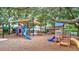 Community playground with slides, climbing structures, and sunshades offers a fun and safe play area for children at 5518 Luminar Pointe Ln, Apollo Beach, FL 33572