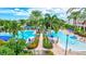 Relaxing pool with palm trees, lounge chairs and landscaping to create a calm, resort-like experience for community members at 5518 Luminar Pointe Ln, Apollo Beach, FL 33572