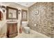 Charming powder room with a decorative vanity, tile accent wall and stylish fixtures at 5518 Luminar Pointe Ln, Apollo Beach, FL 33572