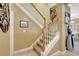 Carpeted staircase with white railings and wooden banister at 5518 Luminar Pointe Ln, Apollo Beach, FL 33572