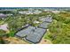 Aerial view of community tennis courts surrounded by lush landscaping, offering a great recreational amenity for residents at 5518 Luminar Pointe Ln, Apollo Beach, FL 33572