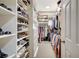 Spacious walk-in closet with custom shelving and ample storage space for shoes, clothes, and accessories at 5518 Luminar Pointe Ln, Apollo Beach, FL 33572