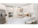 Bright kitchen featuring white cabinets, quartz countertops, and stainless steel appliances at 719 Steel Dr, Apollo Beach, FL 33572