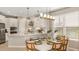 Bright kitchen and dining space with white cabinetry, stainless steel appliances, and ample natural light at 719 Steel Dr, Apollo Beach, FL 33572